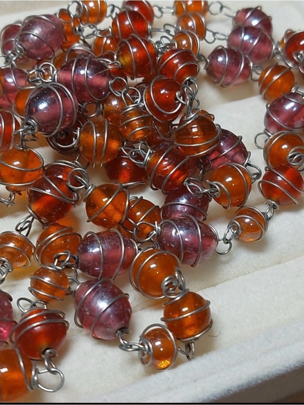Opera length glass bead necklace with delicate metal filigree